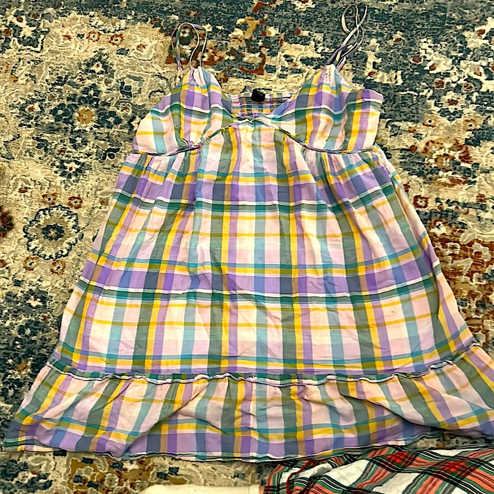 a mini dress with a plaid patter and ruffles at the bottom.